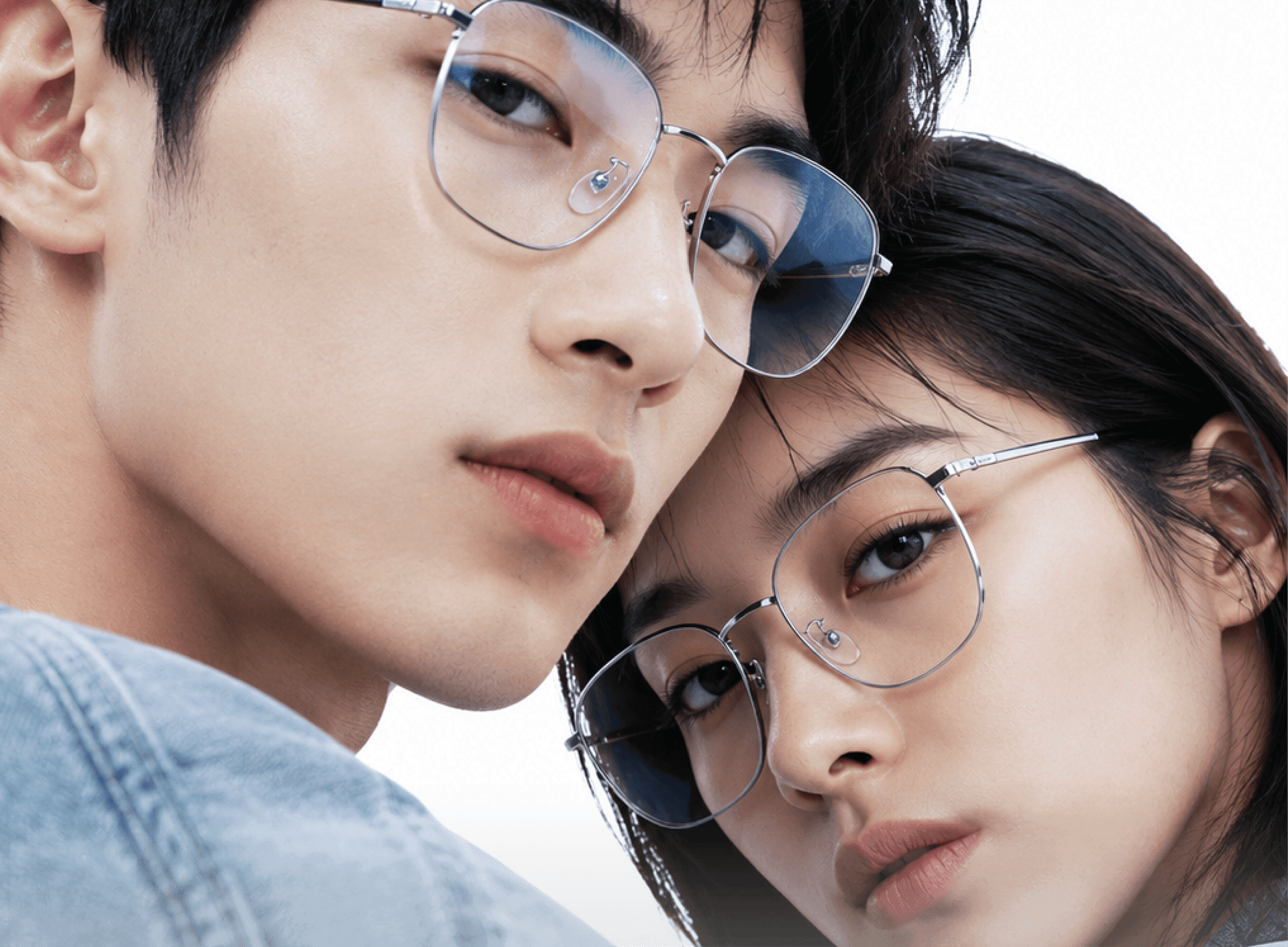 Two people wearing custom prescription glasses